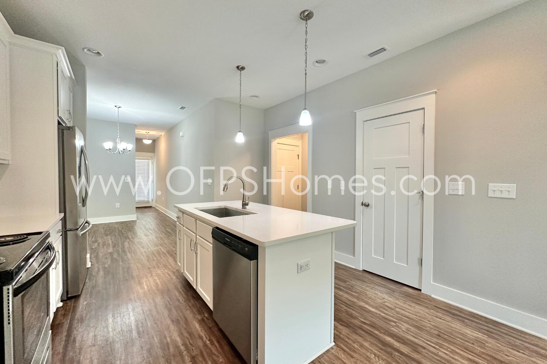 400 Mattie M Kelly Boulevard, Unit 54 Destin, FL 32541 - Photo 8 of 29 a kitchen with a sink stove and wooden floor
