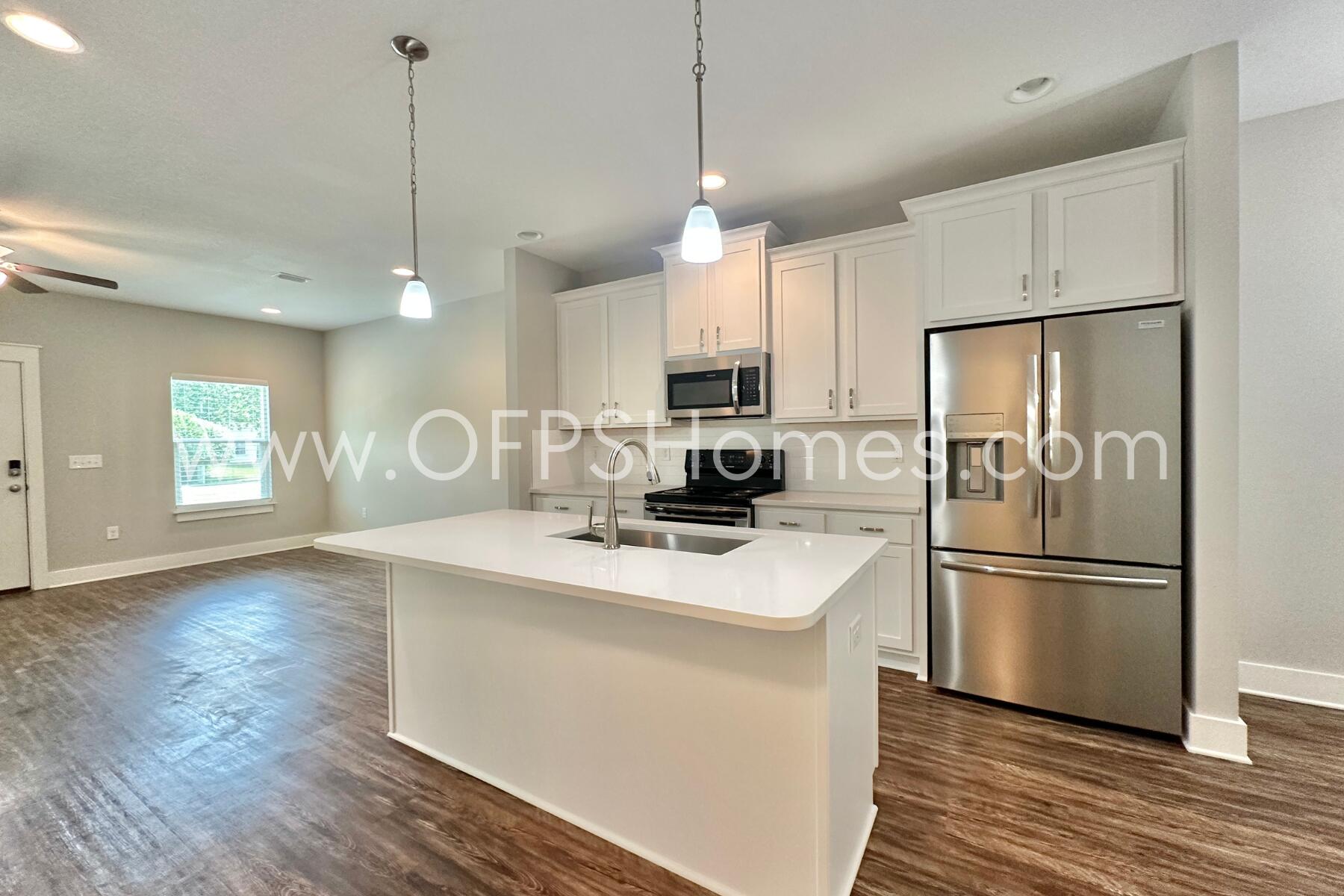 400 Mattie M Kelly Boulevard, Unit 54 Destin, FL 32541 - Photo 9 of 29 a kitchen with kitchen island a sink appliances a counter space and a window