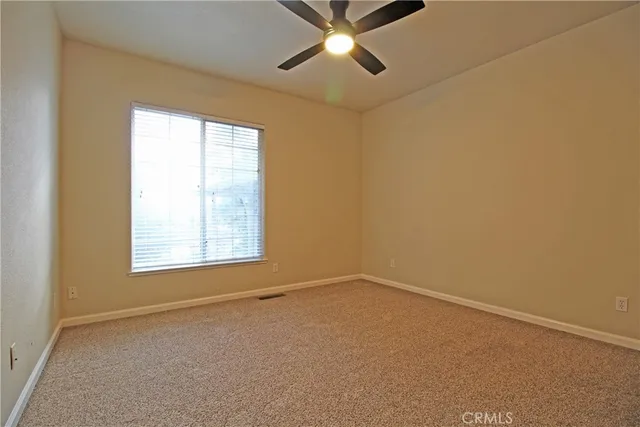 a view of walk in closet with empty room