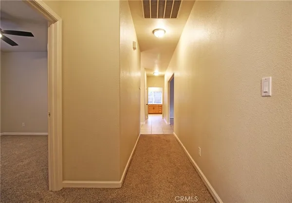 an empty room with a bathroom and a sink