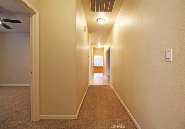 an empty room with a bathroom and a sink