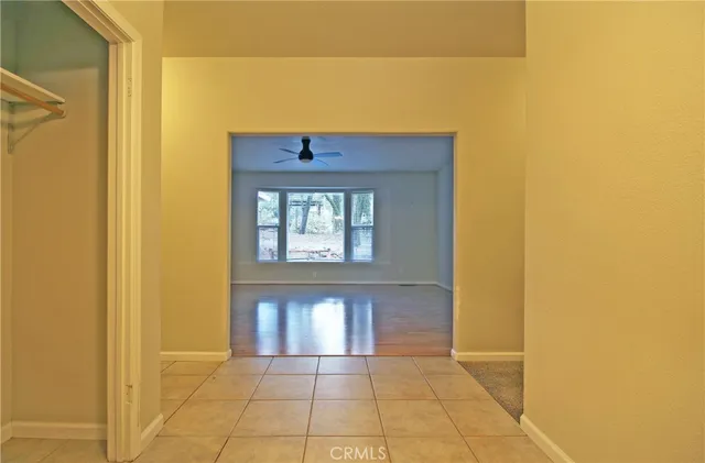 an empty room with windows and closet