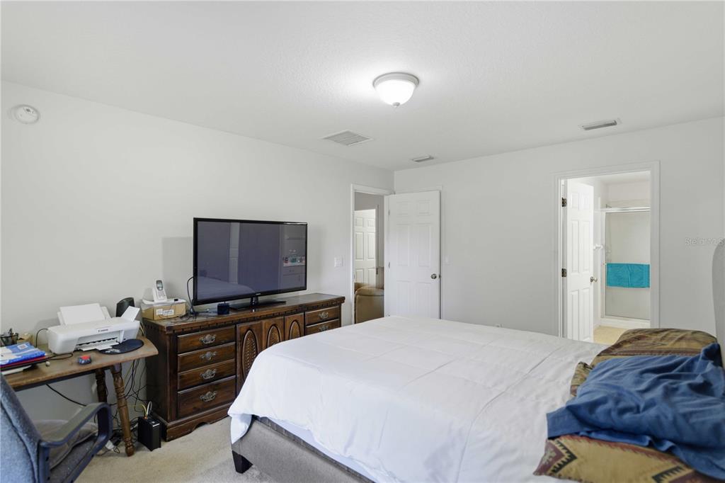 3959 Southwest 129th Street Ocala, FL 34473 - Photo 15 of 27 a bedroom with a bed and a flat screen tv