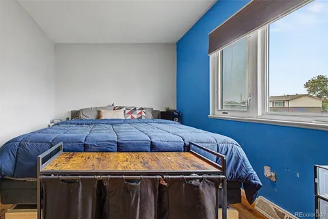 a bedroom with a bed and window