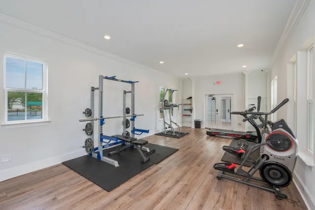 a living room with furniture a window and gym equipment