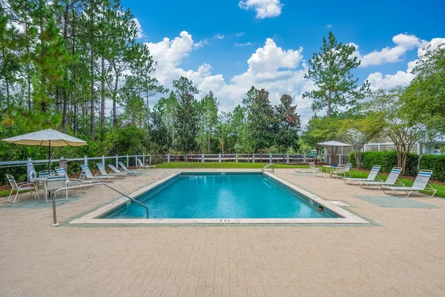 a view of a swimming pool with an outdoor space and seating area
