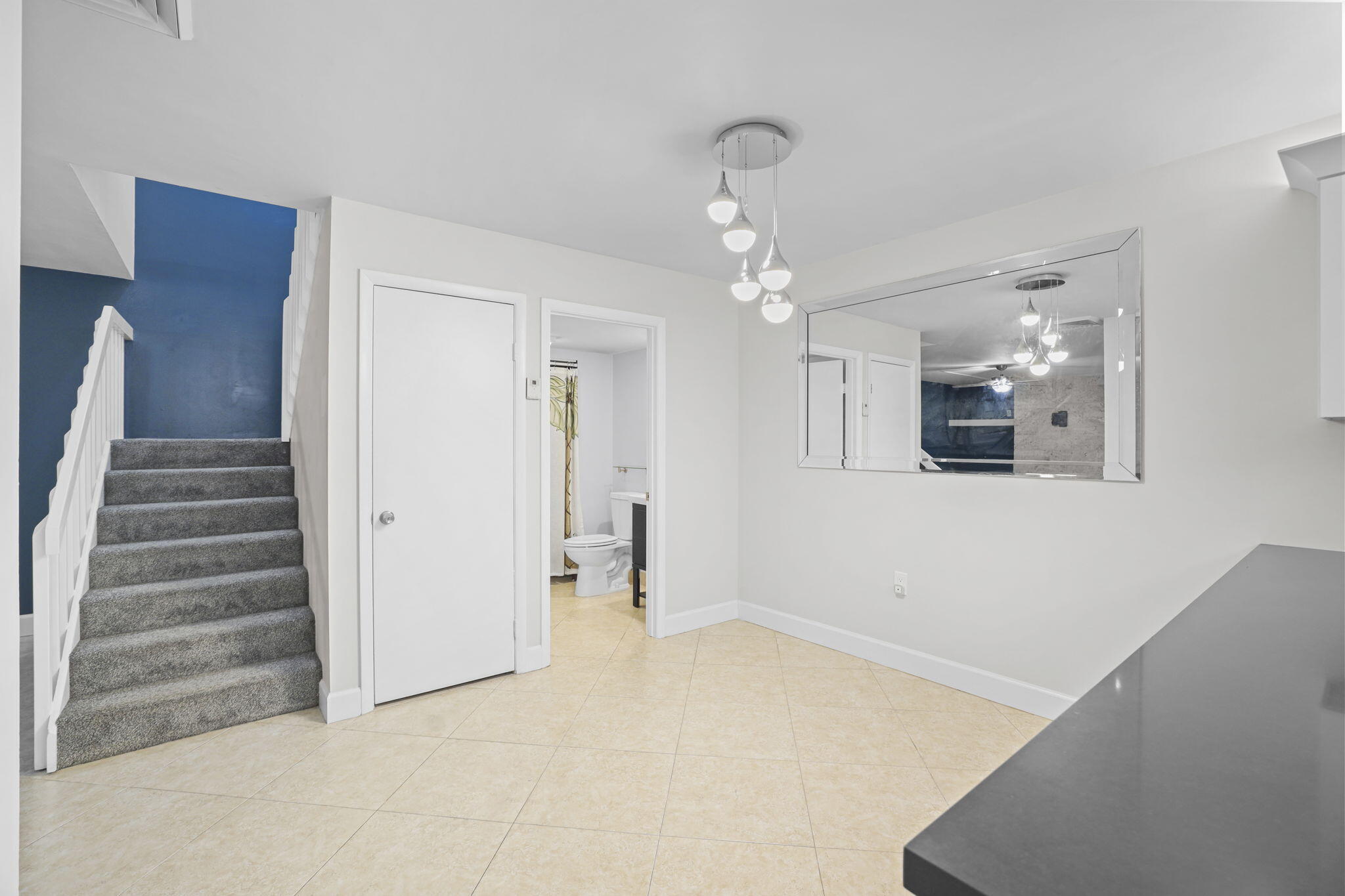 617 6th Lane Palm Beach Gardens, FL 33418 - Photo 13 of 49 a view of an empty room with wooden floor and staircase