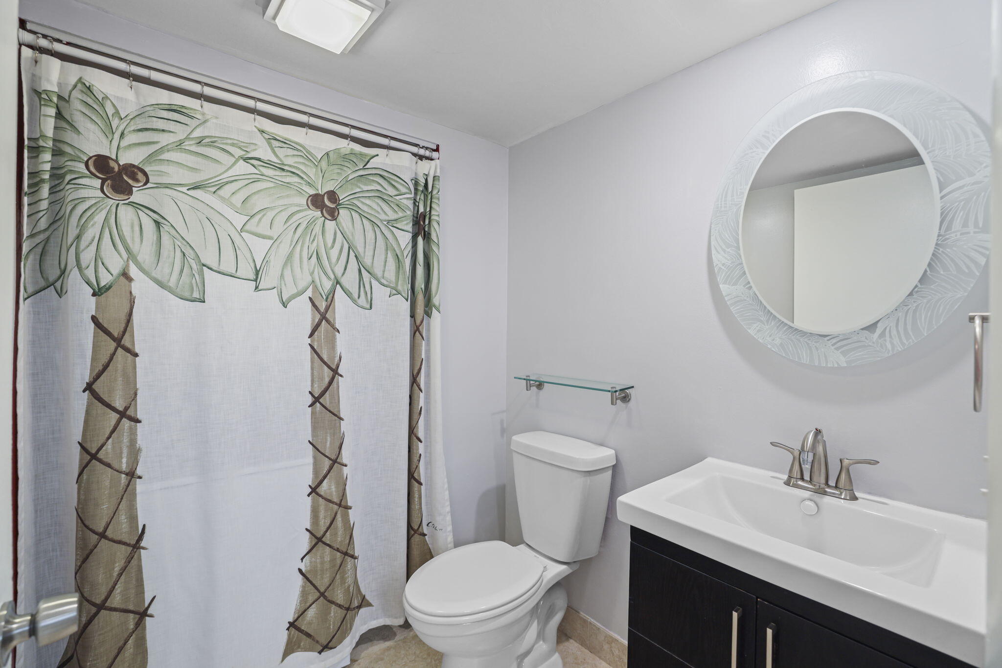 617 6th Lane Palm Beach Gardens, FL 33418 - Photo 14 of 49 a white toilet sitting next to a bathroom sink and a mirror