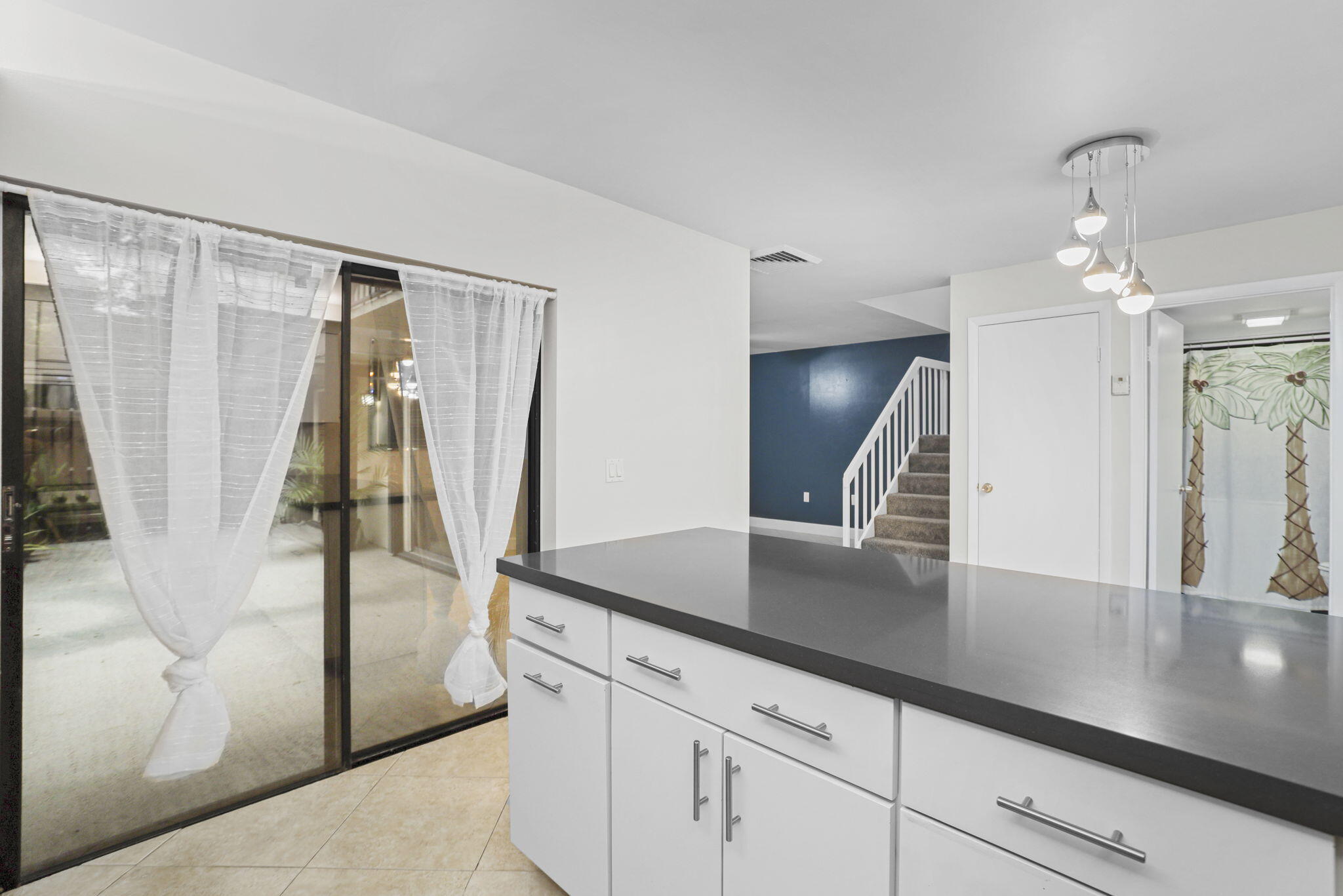 617 6th Lane Palm Beach Gardens, FL 33418 - Photo 16 of 49 a view of a hallway with wooden floor and staircase