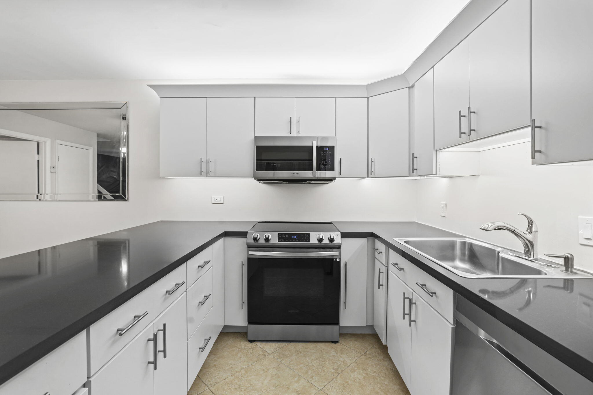 617 6th Lane Palm Beach Gardens, FL 33418 - Photo 20 of 49 a kitchen with granite countertop a stove sink and cabinets