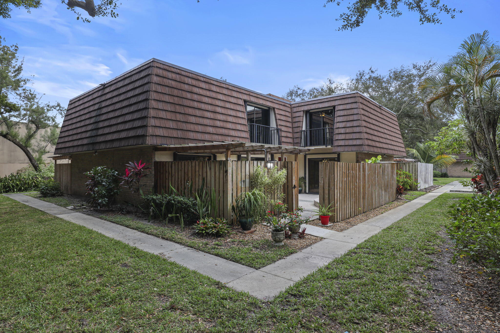 617 6th Lane Palm Beach Gardens, FL 33418 - Photo 3 of 49 a front view of a house with garden
