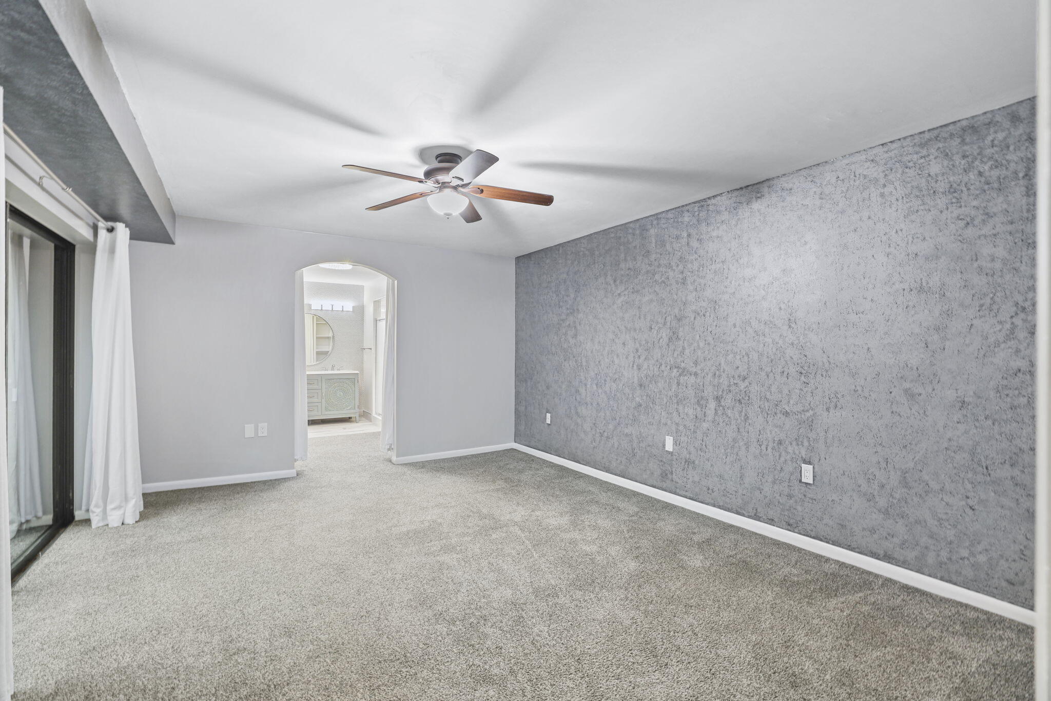 617 6th Lane Palm Beach Gardens, FL 33418 - Photo 31 of 49 an empty room with chandelier fan and windows