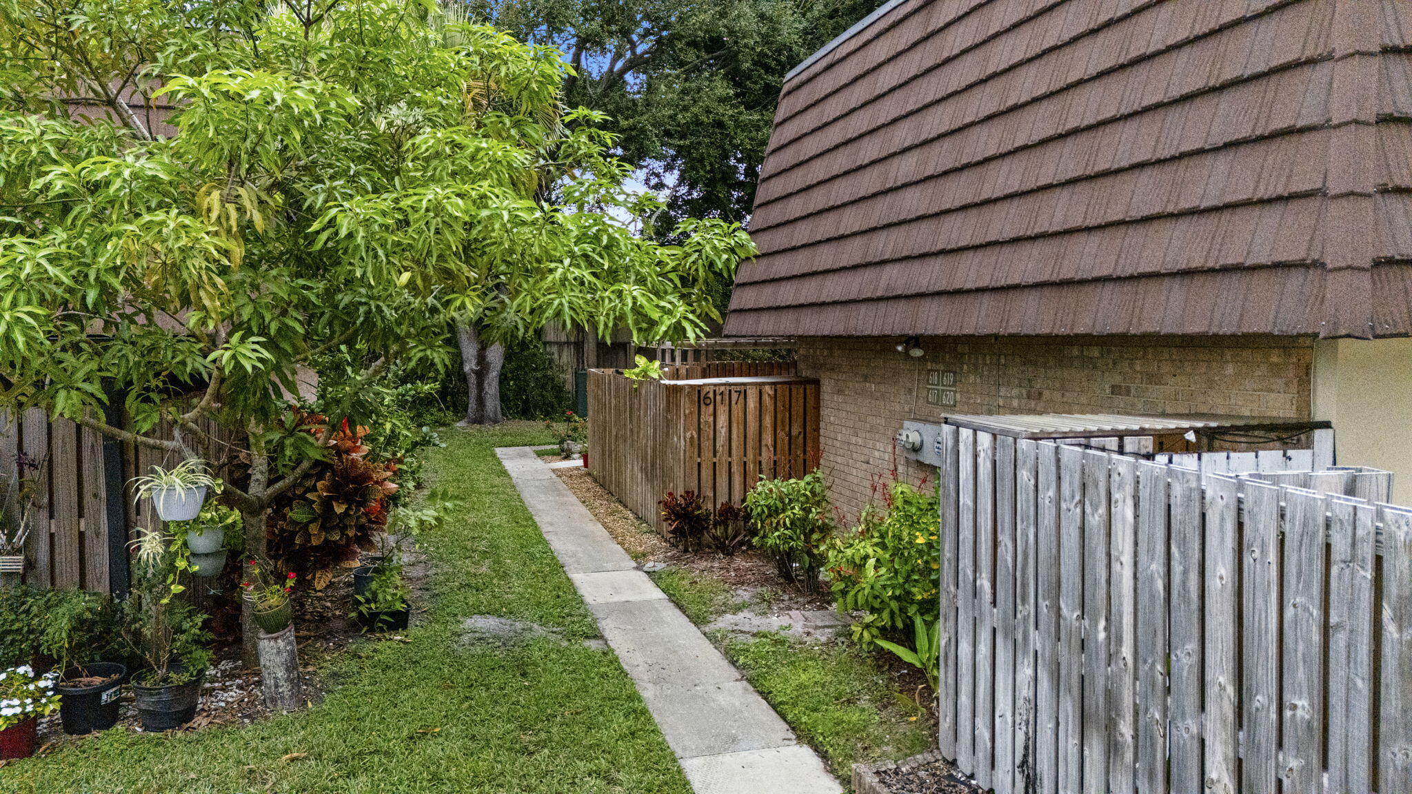 617 6th Lane Palm Beach Gardens, FL 33418 - Photo 40 of 49 a view of a backyard with plants