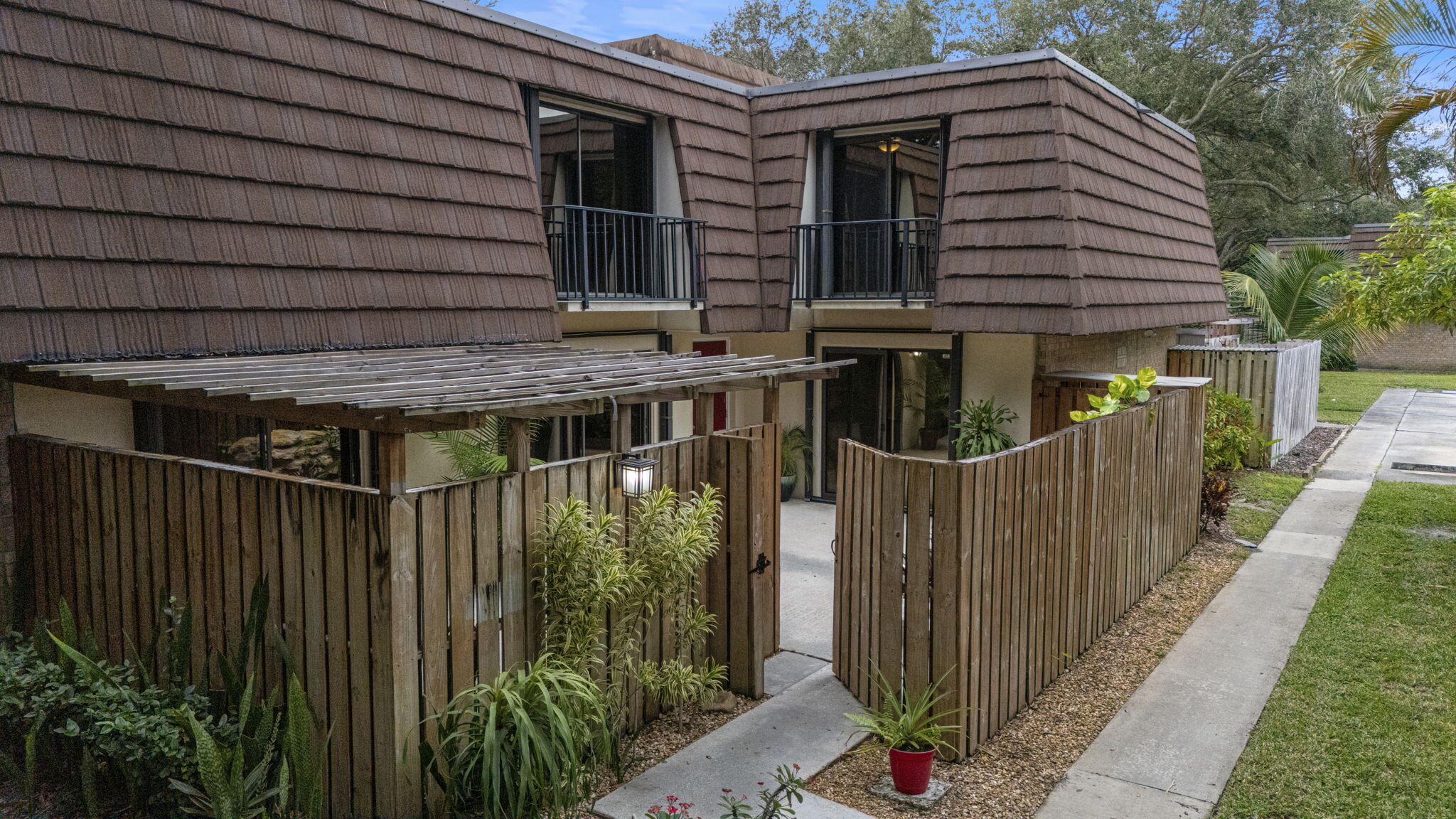 617 6th Lane Palm Beach Gardens, FL 33418 - Photo 4 of 49 a view of house with wooden deck and furniture