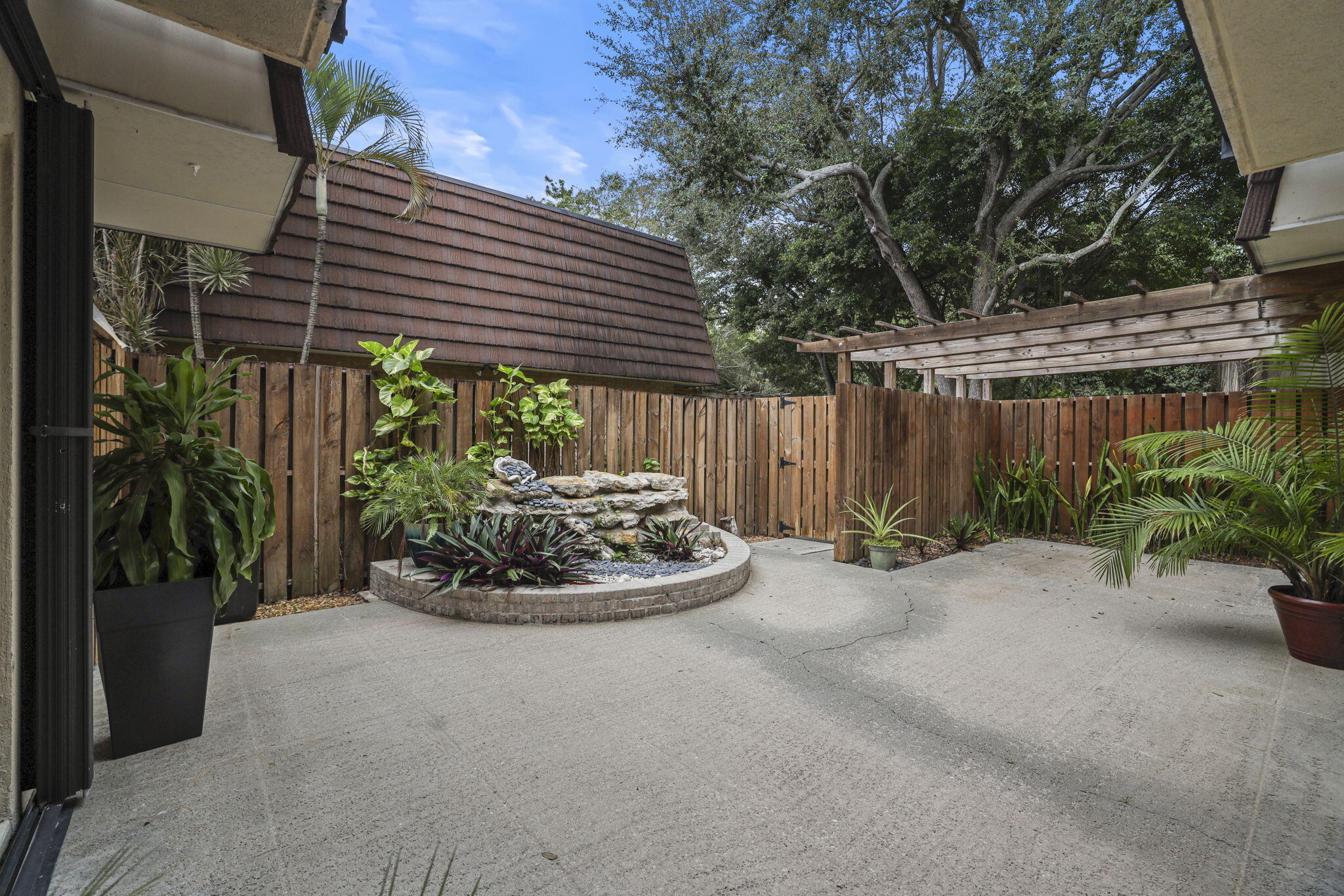 617 6th Lane Palm Beach Gardens, FL 33418 - Photo 5 of 49 a house with lots of trees in the background