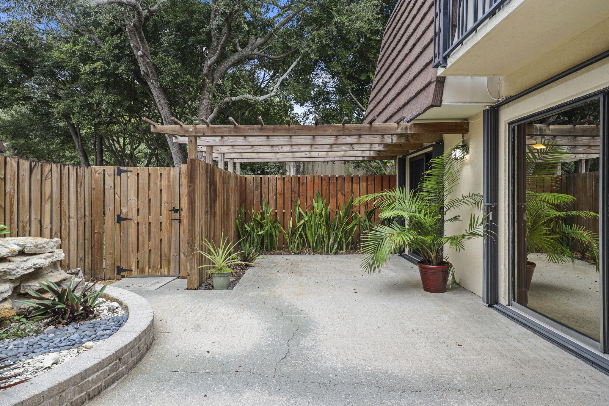 617 6th Lane Palm Beach Gardens, FL 33418 - Photo 6 of 49 a view of potted plants in front of door