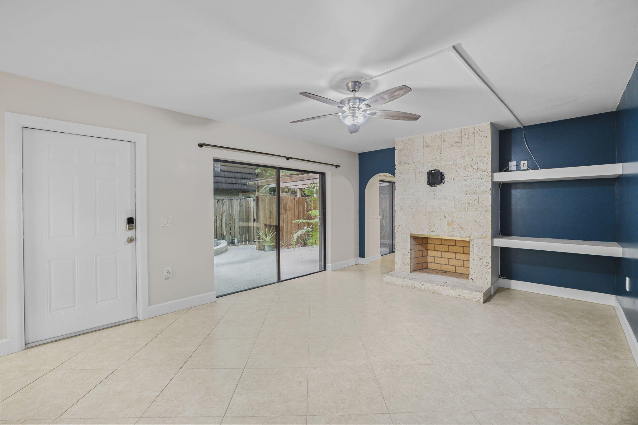 617 6th Lane Palm Beach Gardens, FL 33418 - Photo 9 of 49 an empty room with chandelier fan and windows