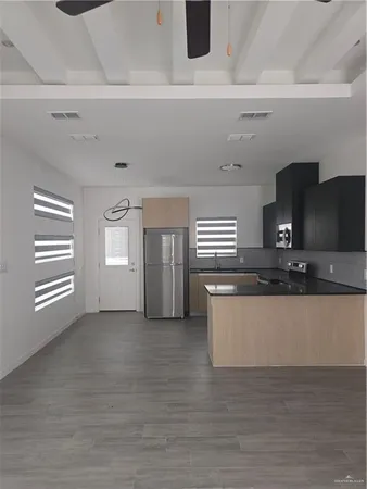 a kitchen with stainless steel appliances granite countertop a sink and a stove