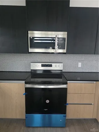 a stove top oven sitting inside of a kitchen