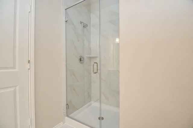 a bathroom with a glass shower door