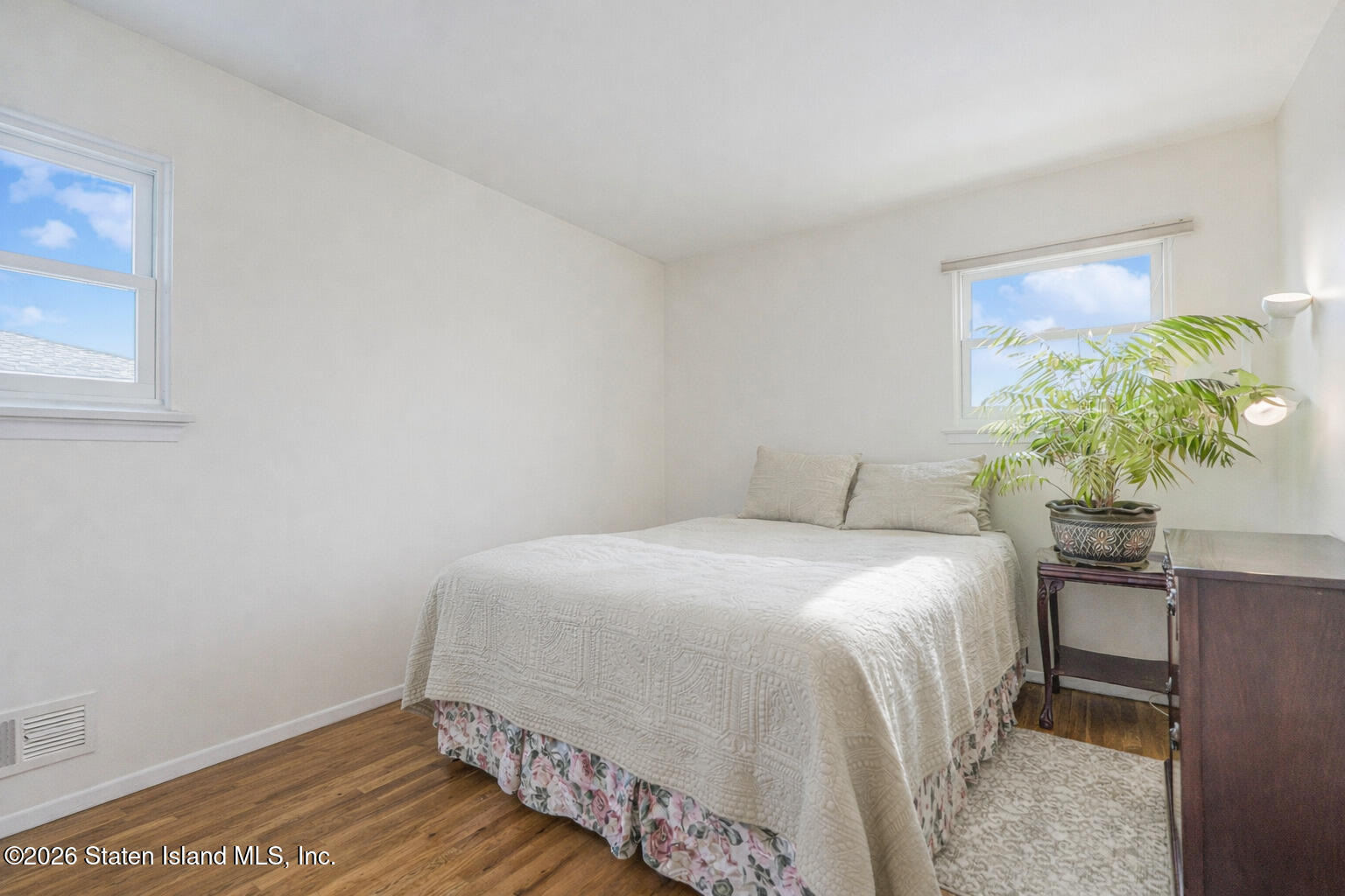 76 Berry Avenue Staten Island, NY 10312 - Photo 17 of 42 a bedroom with a bed and a potted plant