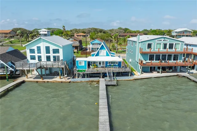 a view of a house with pool and deck