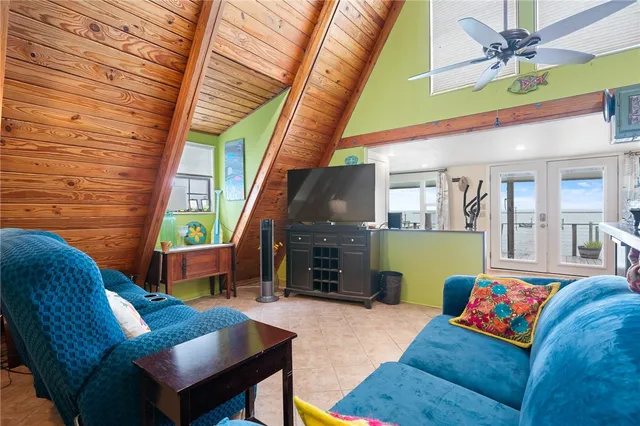 a living room with furniture a fireplace and a table