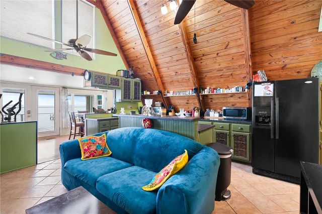 a living room with stainless steel appliances kitchen island granite countertop furniture and a kitchen view