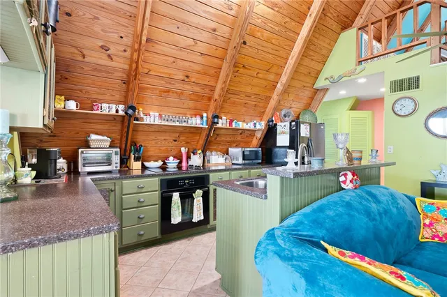 a kitchen with stainless steel appliances kitchen island granite countertop a sink and cabinets