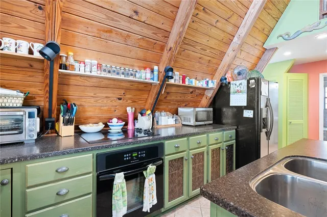 a kitchen with stainless steel appliances granite countertop a sink a stove and cabinets
