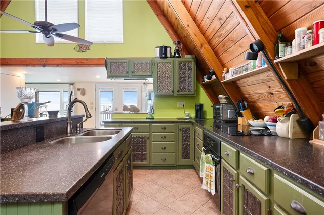 a kitchen with stainless steel appliances granite countertop a sink and cabinets