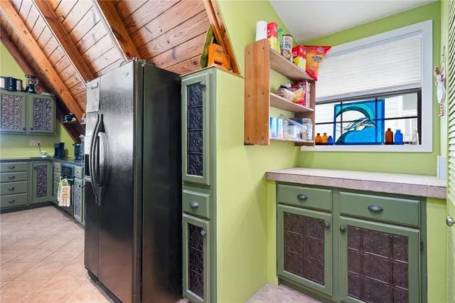 a bedroom with a bed a dresser with wooden floor