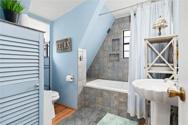 a bathroom with a bathtub and a window