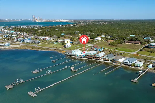 an aerial view of a house with a ocean view
