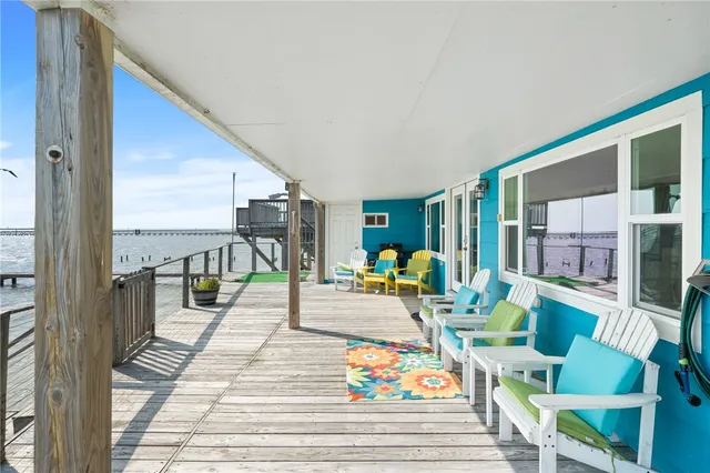 a dining room with furniture and a floor to ceiling window