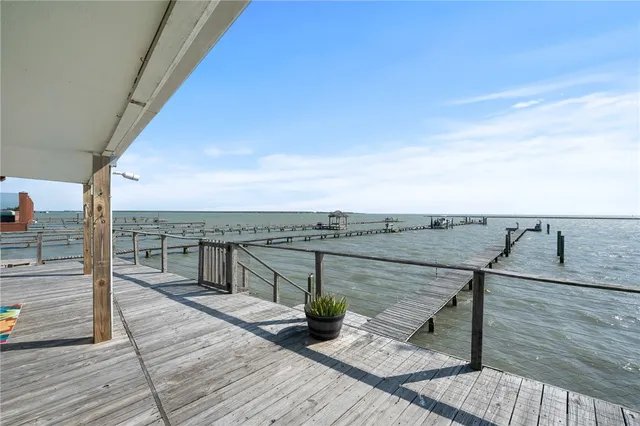 a view of a terrace with wooden floor and iron stairs