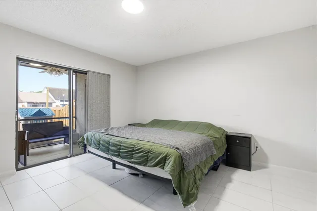 a bedroom with a bed and large window