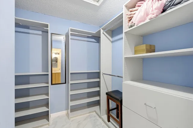 a view of walk in closet with empty racks