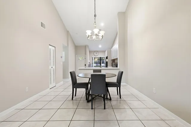 a view of a balcony with furniture and floor to ceiling window