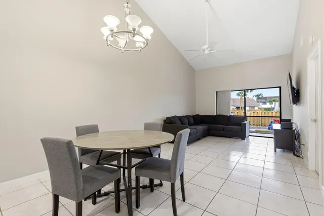 a view of a dining room with furniture and chandelier