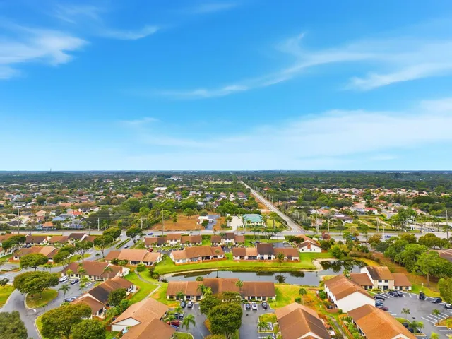 an aerial view of residential houses with city view