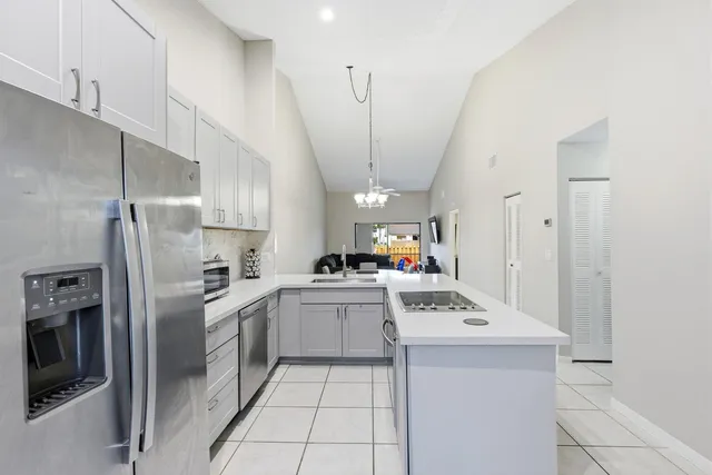 a kitchen that has a lot of cabinets in it and appliances