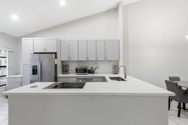 a kitchen with a white cabinets and white appliances