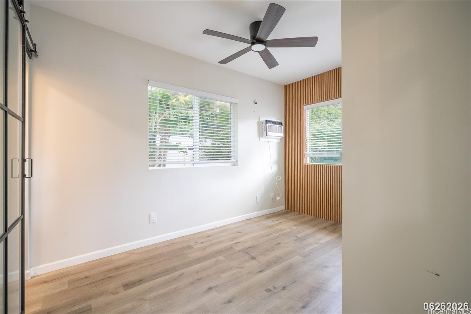 87-1409 Akowai Road Waianae, HI 96792 - Photo 23 of 25 a view of an empty room with wooden floor and a window