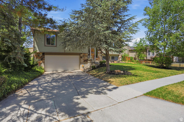 8938 Manchester Lane Sandy, UT 84093 - Photo 49 of 50 Split-level residence featuring a two-car garage with a concrete driveway
