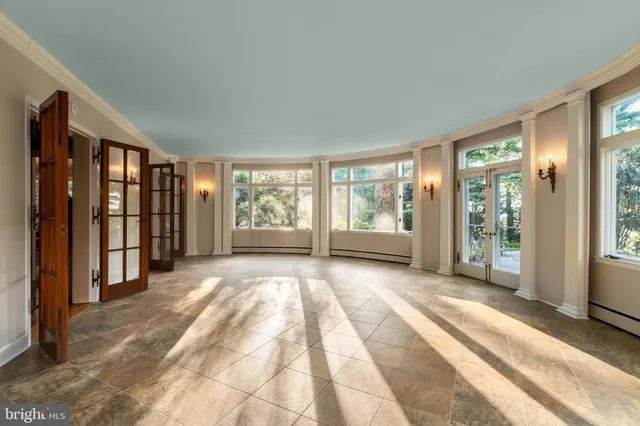 a view of an empty room with large windows