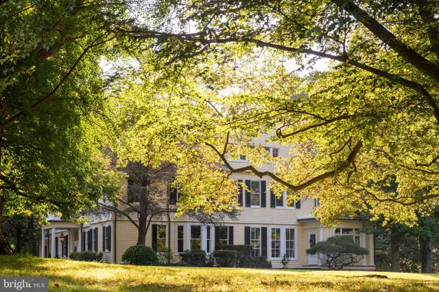 a large tree in front of a house