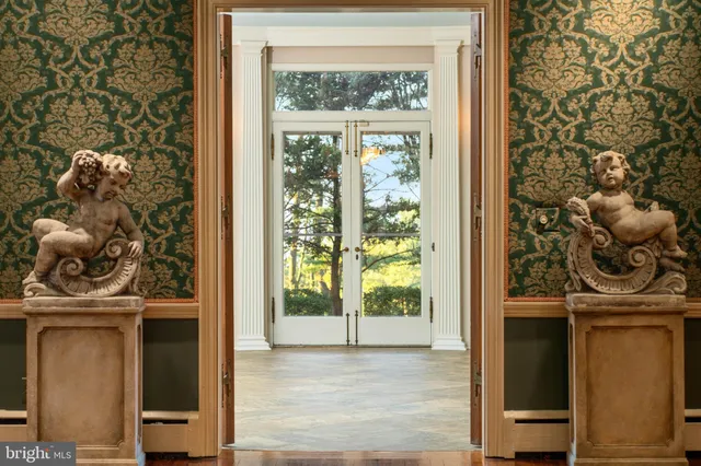 an aerial view of a house with garden space and trees