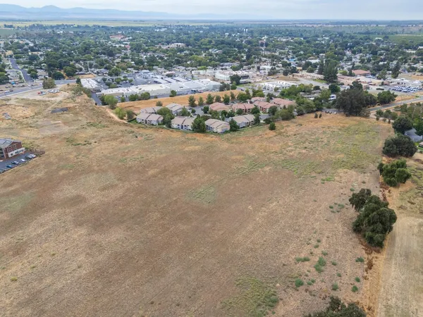 an aerial view of a house with a yard