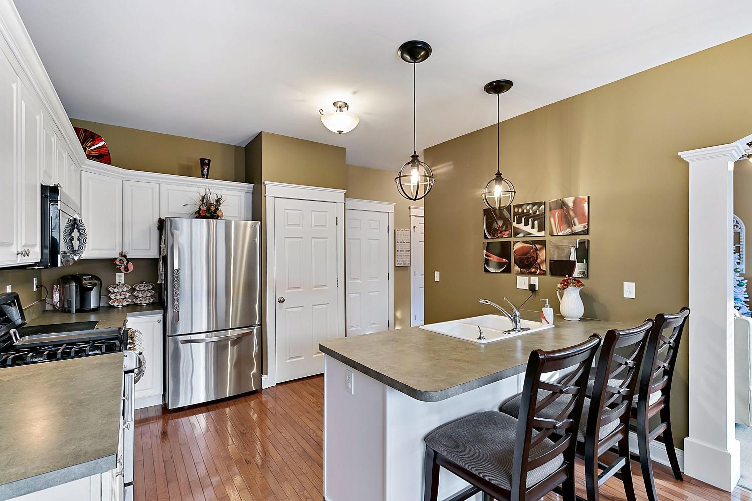 365 Cottage View Terrace Valparaiso, IN 46383 - Photo 5 of 17 a kitchen with stainless steel appliances a dining table chairs refrigerator and sink